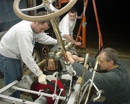 1911 Cadillac Model 30 Demi Tonneau DSC00005 Sean, Jeff, and Brock fitting the engine into the chassis. (Status as of April 2005.)