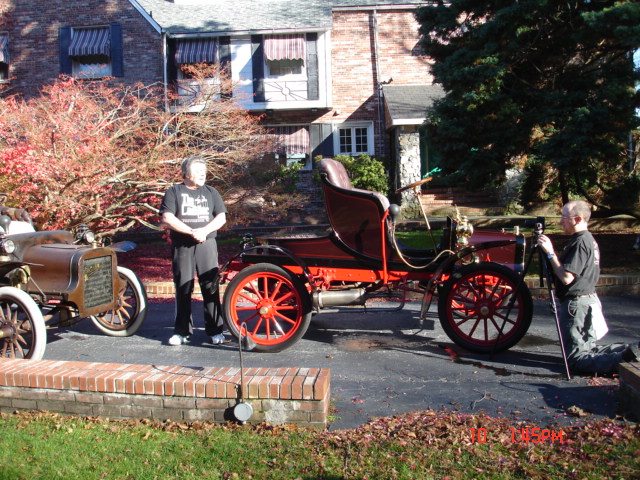 David Adolphus preparing to shoot Dick Shappy with his two 1906 Cadillac model 'K' cars in front of Dick's residence.
