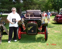 1906 Cadillac Model K Runabout 2006-06-21 DSC00836 Dick Shappy with his freshly restored 1906 Cadillac Model "K" Runabout displaying his "President's Trophy", at the 2006 Cadillac LaSalle New England regional...