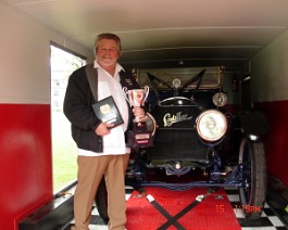 DSC03999 Dick Shappy with "Best of Show" and 1st Place in Class for his 1913 Cadillac Model 30 Phaeton staying inside his car carrier because of rain. New England...