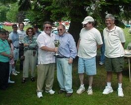 dsc00211 Dick Shappy (left) being presented the 2004 New England Cadillac LaSalle Best Of Show trophy by national director, Richard Esposito along with regional...