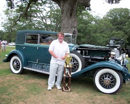 100_0954 Dick Shappy standing in front of his 1930 Cadillac V-16 Convertible Sedan while holding "Best of the Best" award, July 25, 2010.