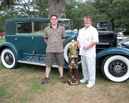 100_0957 Dick Shappy with Greg McDermott standing in front of Dick's 1930 Cadillac V-16 Convertible Sedan while holding "Best of the Best" award, July 25, 2010.