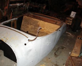 Completed roadster body with complete new wood exterior primed and ready for paint.
